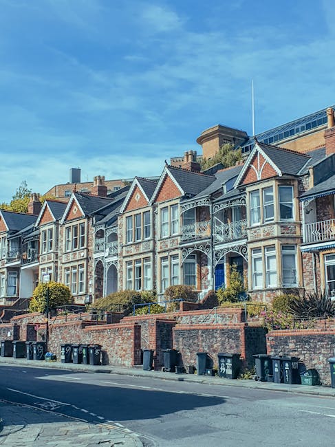 Photograph of a three-storey Victorian-style residential property with a yellow brick facade, white decorative window trim, and a pitched slate roof. The entrance is on the left side, featuring a whit